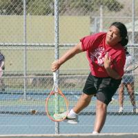 Jacob Richey follows through on a serve