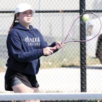 Dalanda Robb hits a two-handed backhand return shot