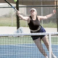 Melanna Idell jumps to reach a forehand return at the net
