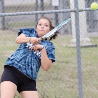 Jayna Graham leans back as she follows through on a forehand return