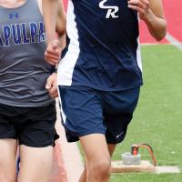 Jacob Long leads a runner from Sapulpa during the 3,200-meter run