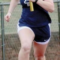 Emercyn Looper carries the baton through a curve in the 4x200-meter relay