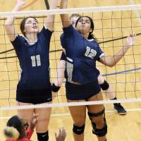 Cassie Avendano and Madison Nichols arrive to block a shot at the same time