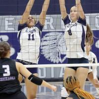 Meredick Martinez (11) and Brantlie Charmasson (8) combine for a double block attempt
