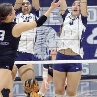 Meredick Martinez (left) and Ruby Curtis combine for a double block attempt