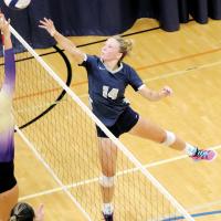 Bailey Denwalt tips a shot over a Chickasha player at the net