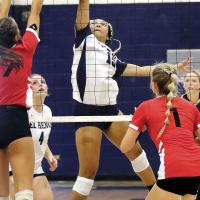 Qyra Jones tips the ball at the net