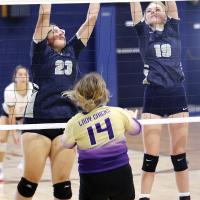 Savannah Robinson and Avery Peffer team up for a double block attempt
