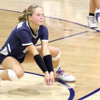 Bailey Denwalt bends down to dig up a shot