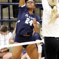 Michaela Reed hits a kill attempt around a Duncan blocker