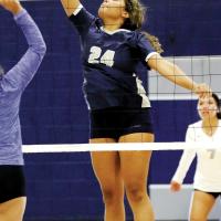 Pauline Black-Harmon hits a shot at the net