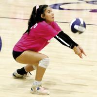 Makenna Curtis digs up a shot by Noble