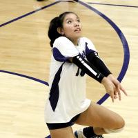 Makenna Curtis drops to a knee to dig up a shot