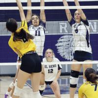 Meredick Martinez (11) and Brantlie Charmasson (8) get their hands up in front of a kill attempt