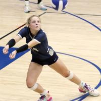 Bailey Denwalt lunges out to pick up a serve
