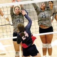Lily Elliott (15) and Trinity Black (25) attempt a block