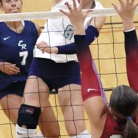 Brantlie Charmasson tries to hit through a block at the net by Tuttle
