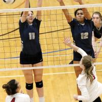 Cassie Avendano and Madison Nichols attempt a block