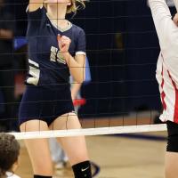 Avery Peffer tries to hit around a block attempt