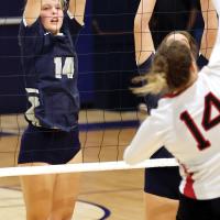 Bailey Denwalt sets up a block attempt at the net