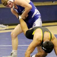 EHS wrestling_Law pulls tight a singleleg takedown