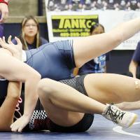 Lilie Arrasmith works to try and roll WHS’ Bella Butler to her back