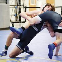 Hollis Gore twists an Altus wrestler to the mat en route to a takedown