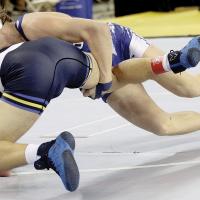 Preston Scott throws a wrestler to the mat