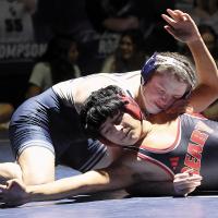 Kysen Pannell presses his chin into the shoulder of Geary’s Terril Rednose as he tries to pull his back to the mat