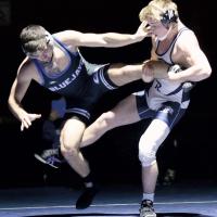 Will Heger, right, sweeps at the back leg of Guthrie’s Braden Hall