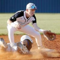 Davin Shamblin squints through the dirt to grab a pickoff throw