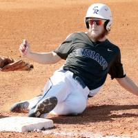 Kolt Glenn slides into third base under the tag from a Southeast player