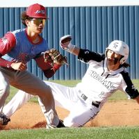 Dacien Ramos slides into second base ahead of a throw to the bag