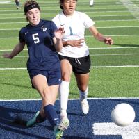 Caroline Huber kicks a low shot at the goal