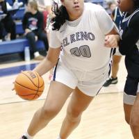Lilly Thomas pushes her way past a defender on a drive to the basket