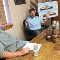 Matt White listens to Adam Fox discuss the new terminal project
