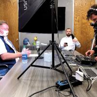 Matt White and Matt Sandidge prepare for the El Reno Live program while Jack Dyer readies the equipment 