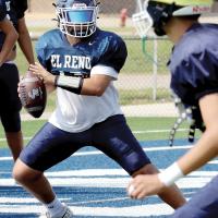 Noah Nicholson rolls away from a pass rush in the end zone