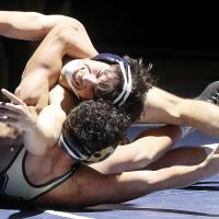 Trevor Robinson grimaces as he rolls out of a takedown