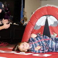 Tanner Hood shows first-grader Ridley Jefrey how to cover her face