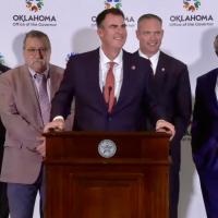 Kevin Stitt (center) answers questions about education funding