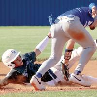 Kyson Jenkins dodges a tag by a Guthrie player on a stolen base attempt