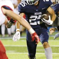 Lathen Pruitt looks to make a cut inside of a would-be Elgin tackler