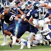 Elijah Fisher tries to break a jersey tackle
