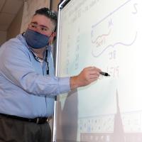 Chris Burdine teaches a problem on a smartboard