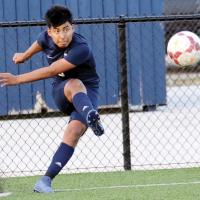 Anthony De Paz watches the ball as he follows through on a corner kick