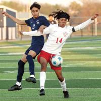 Uriel Arellano climbs on the back of a Del City player as the two try to control a goal kick