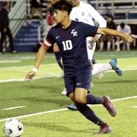Edgar Perez dribbles the ball away from the pursuit of a Southeast player
