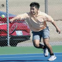 Erik Vazquez attempts a backhand stab return shot