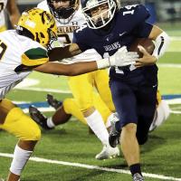 Kade Mayo tries to stiff-arm his way past a defender